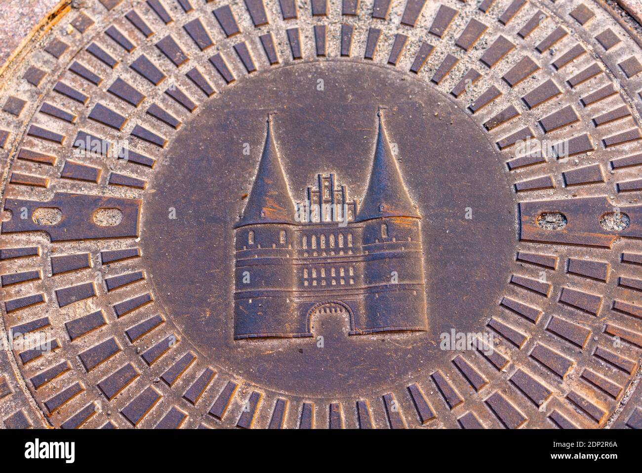 Manhole cover with Lübeck emblem of historic Holsten Gate, Hanseatic City of Lübeck, Schleswig-Holstein, North germany, Europe Stock Photo