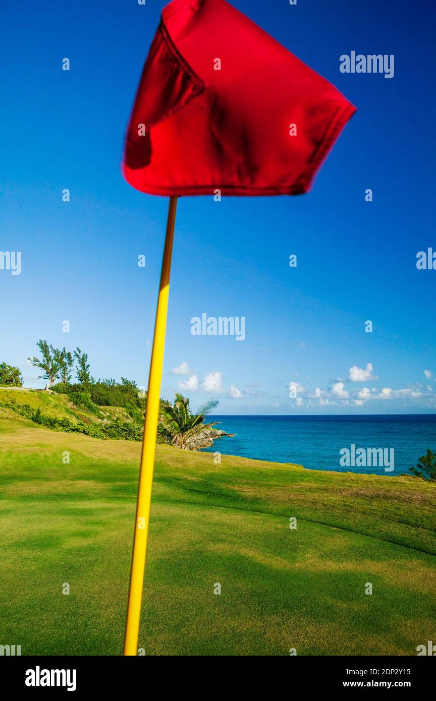 Red flag on putting green; Port Royal Golf Course; Bermuda Stock Photo