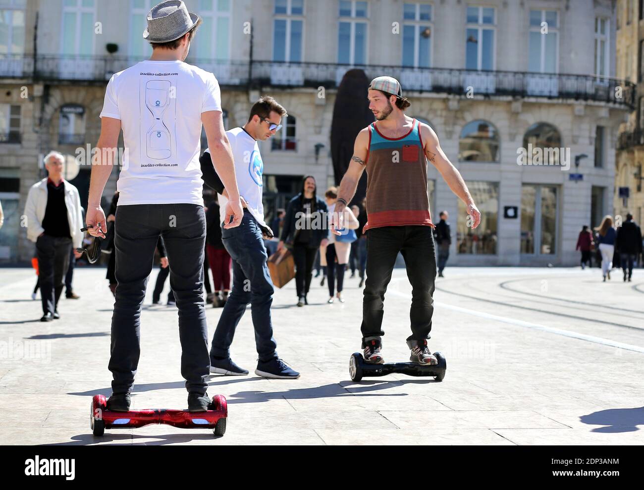 Exclusive. Passers-by test the Hovertrax electric skateboard, a new  motorized means of transportation, on Place de la Comedie square in  Bordeaux, southwestern France on April 7, 2015. The new board comes from