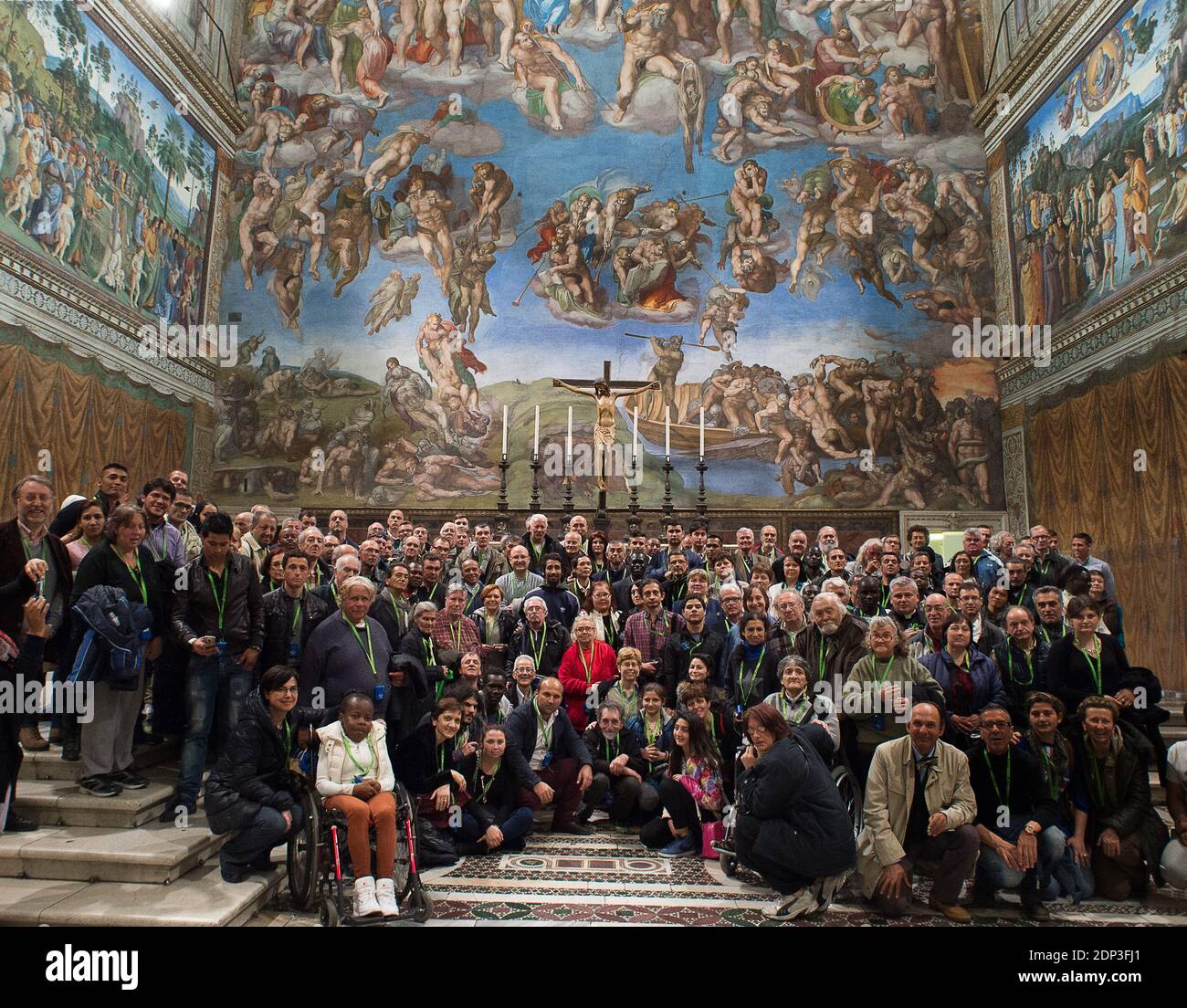 On March 26, 2015 guest of the Vatican a group of 150 homeless people got a private guided tour in the Sistine Chapel .The number of homeless around Saint Peter?s square has doubled in the past six months as the Pontiff makes a difference in the lives of so many people. Instead of trying to eradicate its homeless population the Vatican is actually helping them. Pope Francis has pledged to restore dignity to these persons by providing for their needs, all without judging them. And homeless people are migrating to the Vatican to spend each night in sleeping bags donated by the Church. Police off Stock Photo