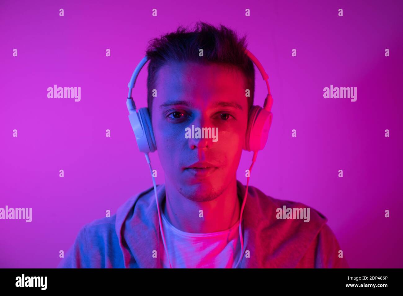 Man Listens to Music With headphones on a Colored Background. Music Poster  Stock Photo - Alamy