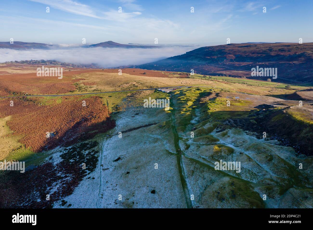 Aerial view looking down through fog on a frosty, frozen rural landscape (Wales, UK) Stock Photo