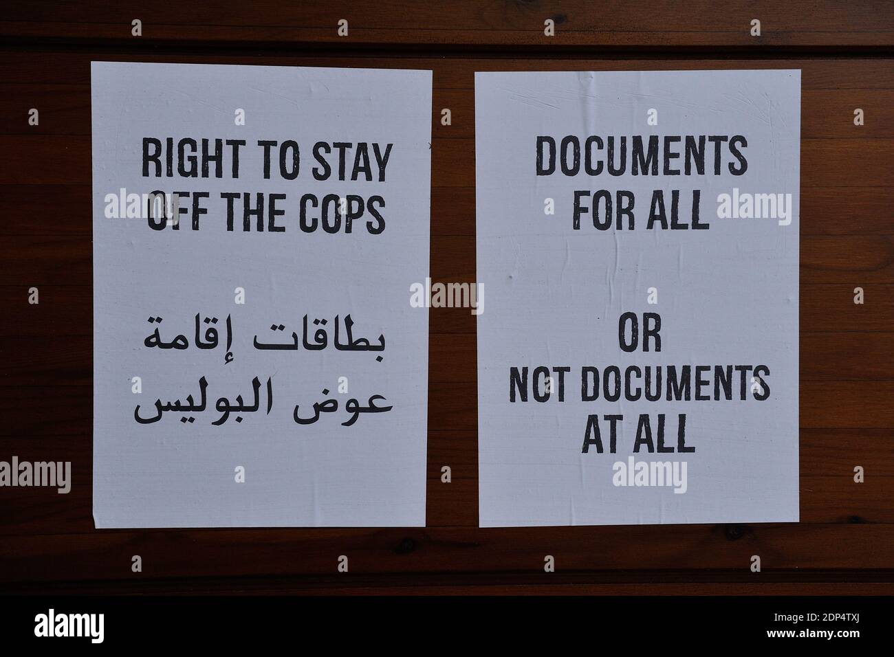 A sign saying 'Documents for all or no documents at all' and another sign saying 'Right to stay off the cops' where migrants from Sudan and Erythree sleep in a camp at Jardin Eole near La Chapelle in Paris, France, on June 19, 2015. Photo by Aurore Marechal/ABACAPRESS.COM Stock Photo