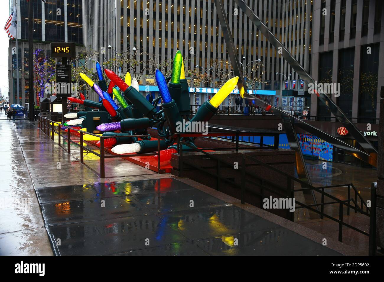 Giant Christmas lights line the sidewalk near Radio City Music Hall in