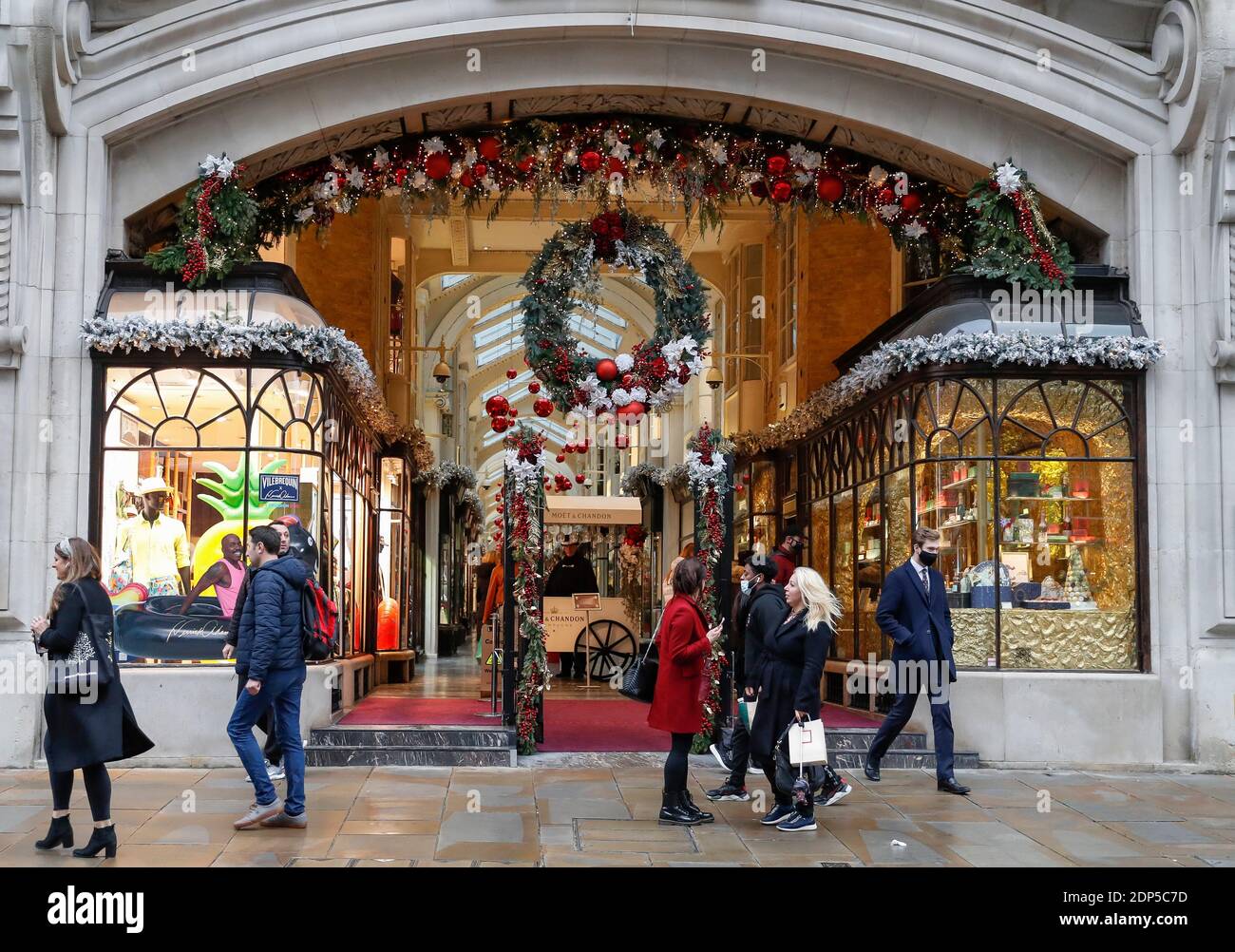 London, Britain. 18th Dec, 2020. People walk past Burlington Arcade on Piccadilly in London, Britain, on Dec. 18, 2020. Britain's coronavirus reproduction number, also known as the R number, has risen to between 1.1 and 1.2 from between 0.9 and 1.0 last week, the British government's Scientific Advisory Group for Emergencies (SAGE) said Friday. The R number is one of many indicators scientists use to determine how fast COVID-19 is spreading in the country. If the R number is above one, it means the number of cases will increase exponentially. Credit: Han Yan/Xinhua/Alamy Live News Stock Photo