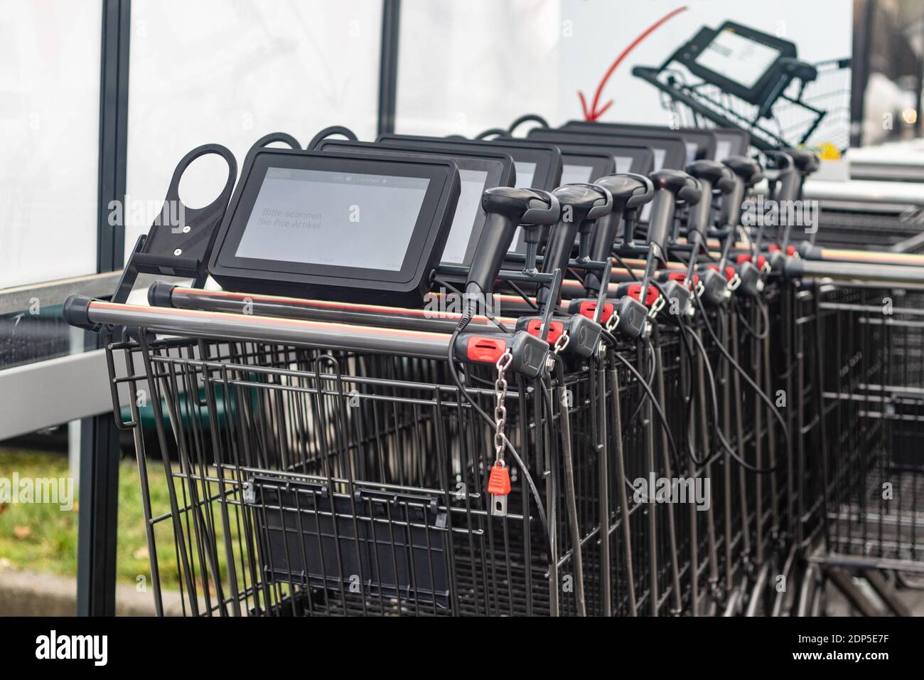 Shopping trolley with scanner system in a row Stock Photo - Alamy
