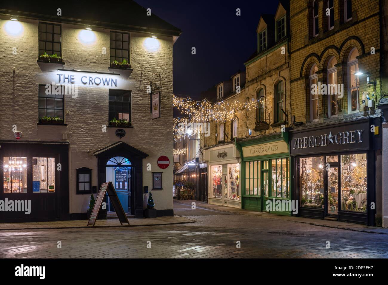 Christmas lights at night along Black Jack Street. Cirencester, Cotswolds, Gloucestershire, England Stock Photo