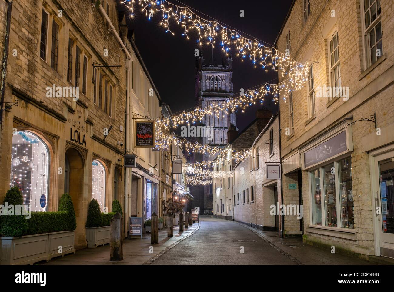 Christmas lights at night along Black Jack Street. Cirencester, Cotswolds, Gloucestershire, England Stock Photo