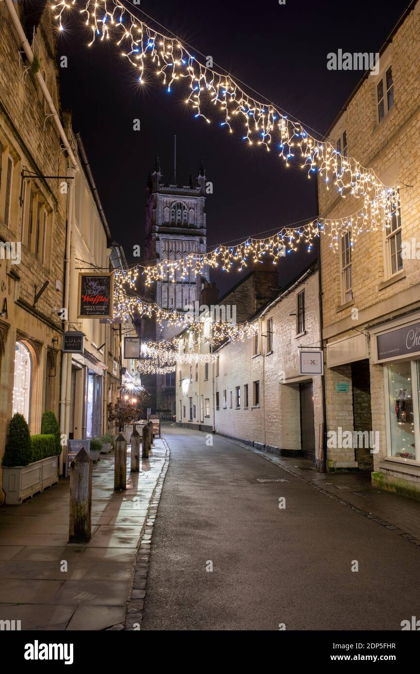 Christmas lights at night along Black Jack Street. Cirencester, Cotswolds, Gloucestershire, England Stock Photo