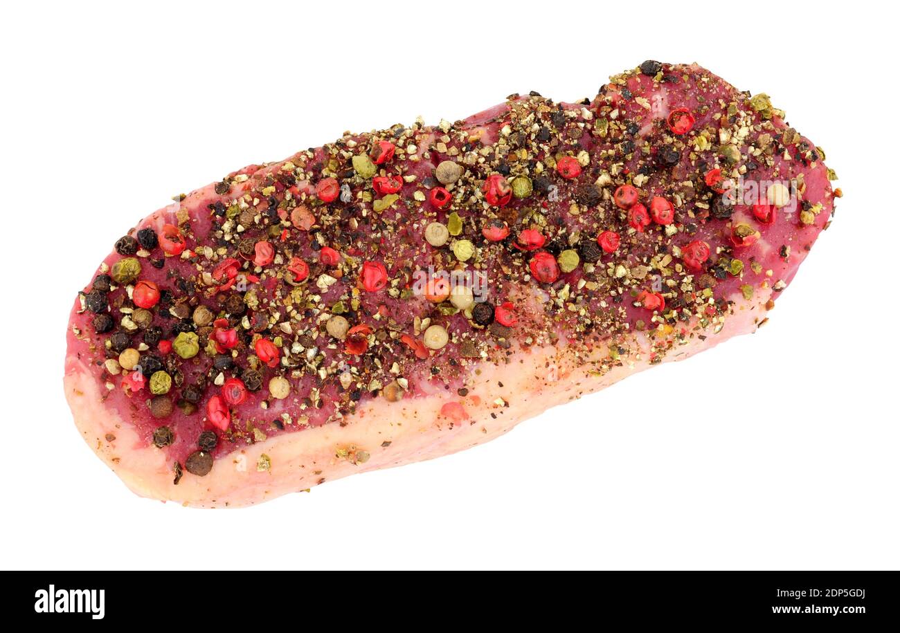 Peppercorn covered raw sirloin steak isolated on a white background Stock Photo