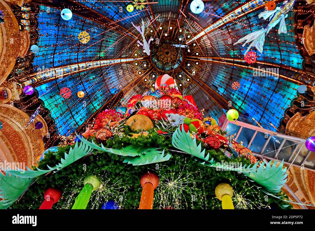Paris, France. 18th Dec 2020. A huge Christmas tree stands in the Galeries Lafayette department store for holiday season on December 18, 2020 in Paris, France. The Galeries Lafayette opened 1912 and was designed by Georges Chedanne and his pupil Ferdinand Chanut, with a huge glass and steel dome, art nouveau staircases and 3 levels of balconies. Photo by Karim Ait Adjedjou/Avenir Pictures/ABACAPRESS.COM Credit: ABACAPRESS/Alamy Live News Stock Photo