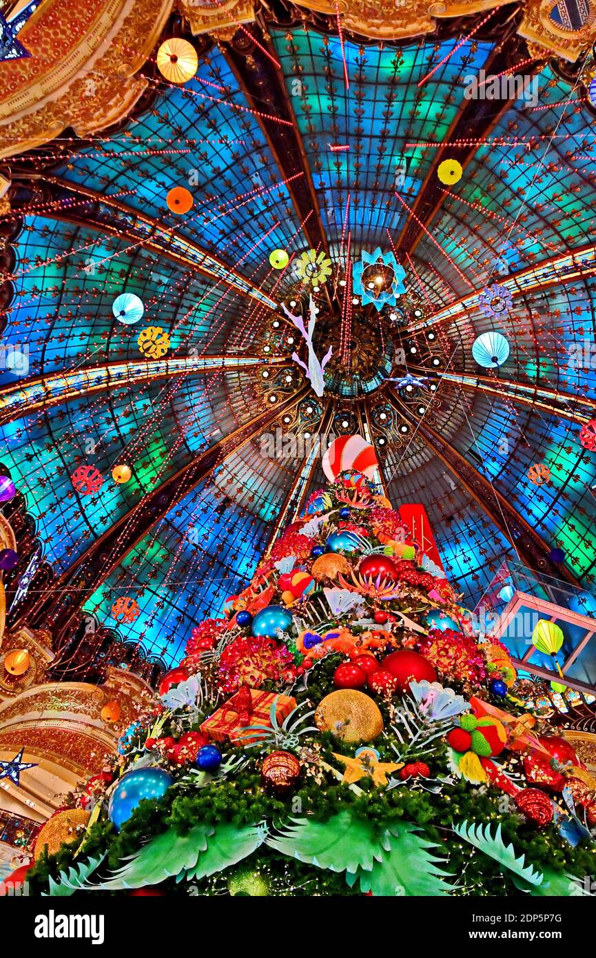 Paris, France. 18th Dec 2020. A huge Christmas tree stands in the Galeries Lafayette department store for holiday season on December 18, 2020 in Paris, France. The Galeries Lafayette opened 1912 and was designed by Georges Chedanne and his pupil Ferdinand Chanut, with a huge glass and steel dome, art nouveau staircases and 3 levels of balconies. Photo by Karim Ait Adjedjou/Avenir Pictures/ABACAPRESS.COM Credit: ABACAPRESS/Alamy Live News Stock Photo