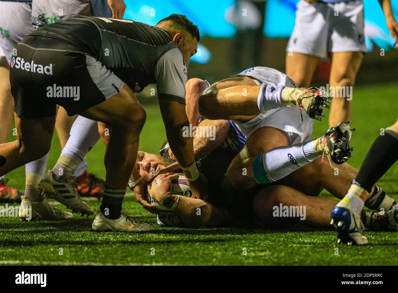 Kyle Cooper of Newcastle Falcons is tackled by Scott Andrews of Cardiff Blues Stock Photo