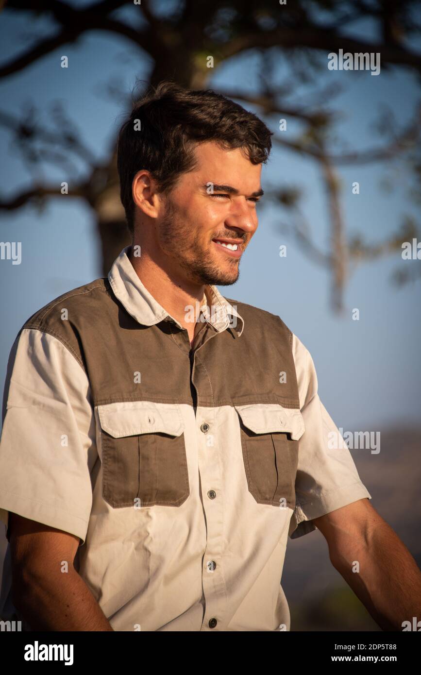 Close-up of safari guide smiling in sunshine Stock Photo