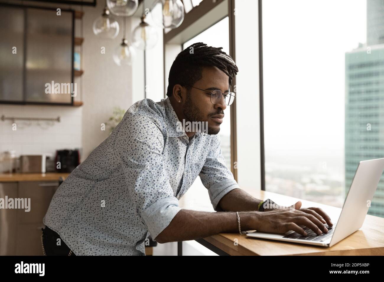 Young biracial man work online on laptop at home Stock Photo