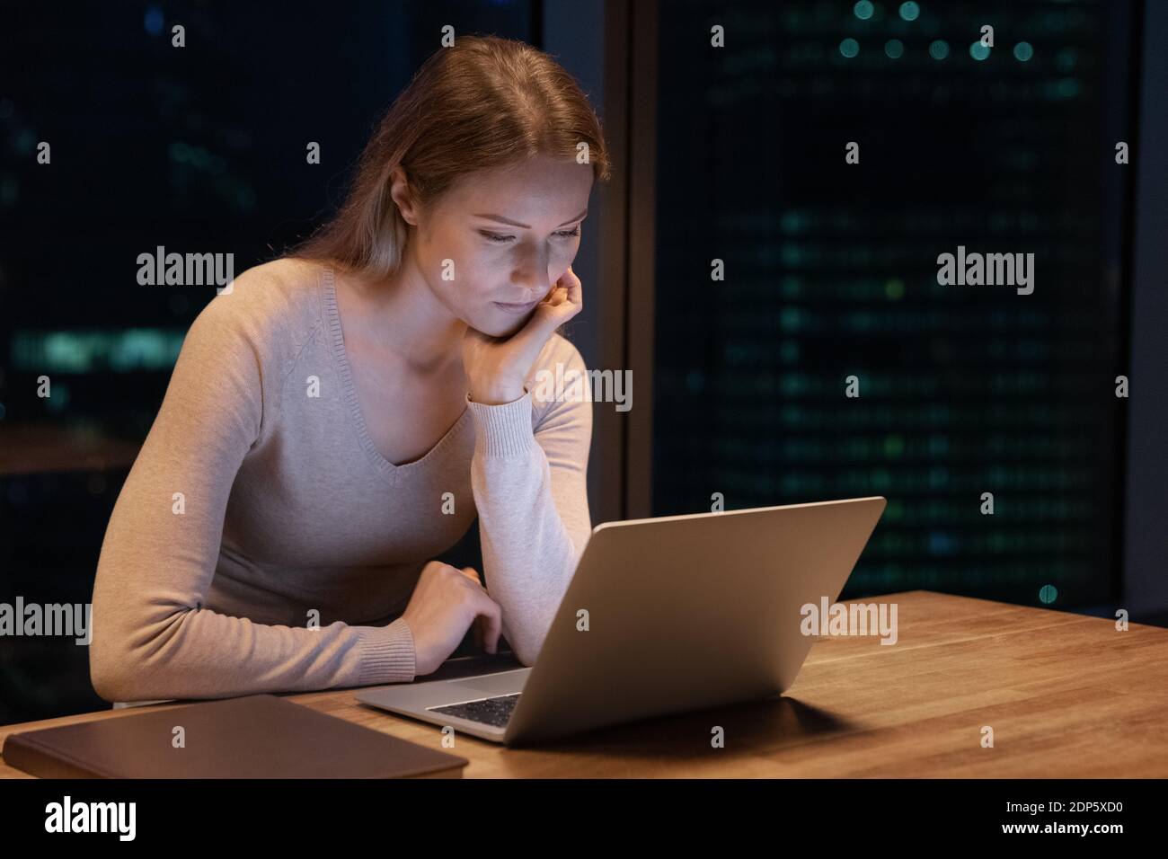 Female employee work on computer in office at night Stock Photo