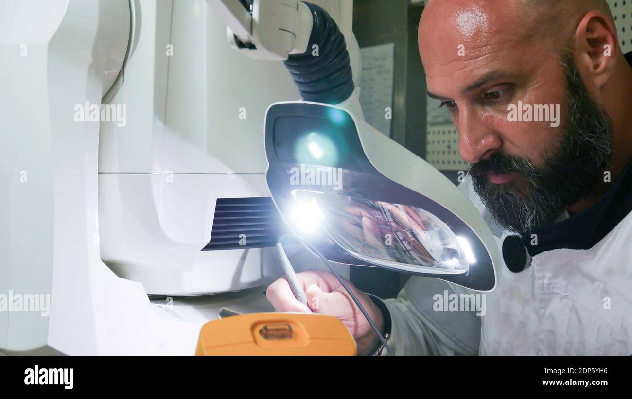Electronics Engineer Works with on Robot. Stock Photo