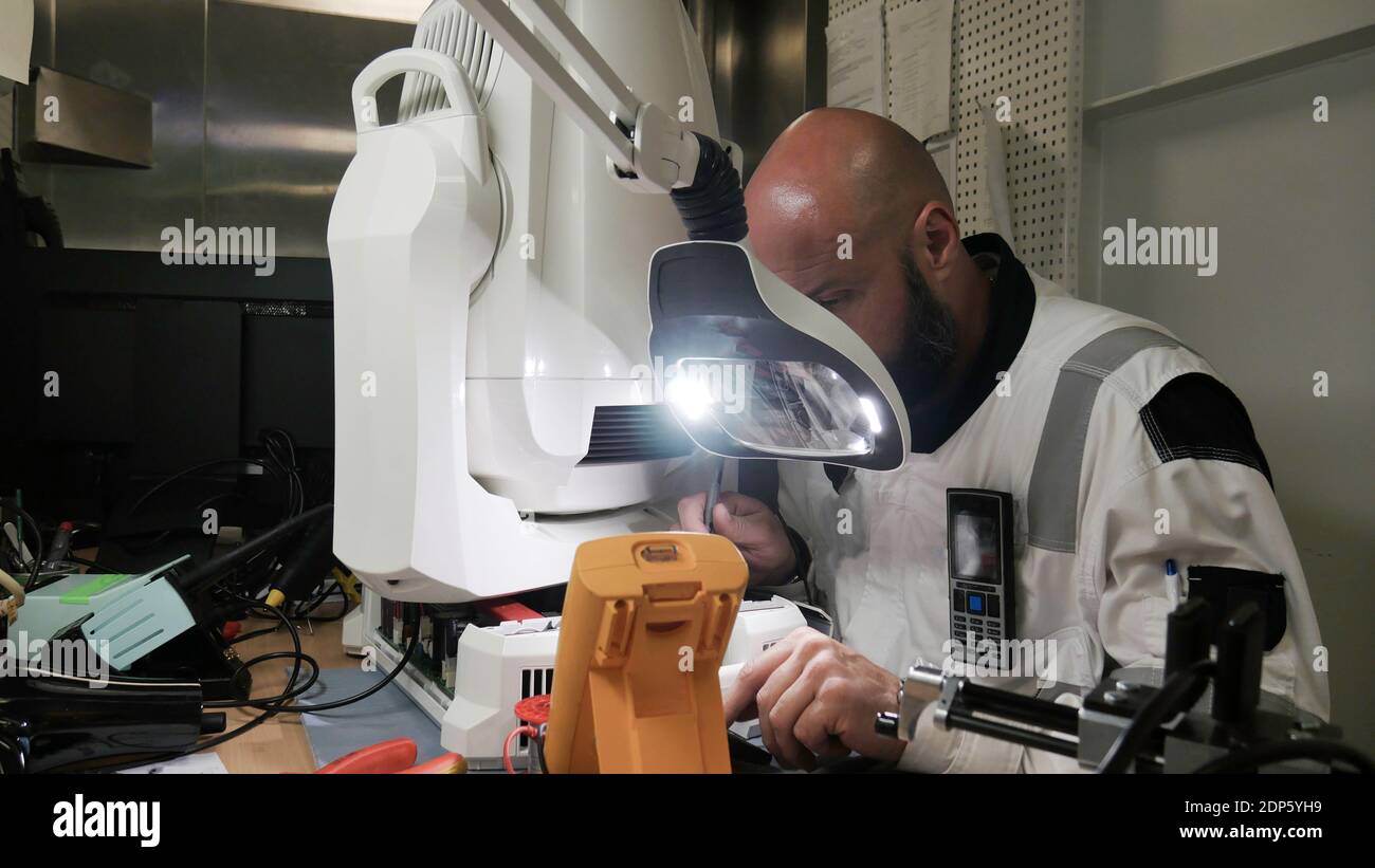 Engineer man measuring electronic product on test bench in his lab ...