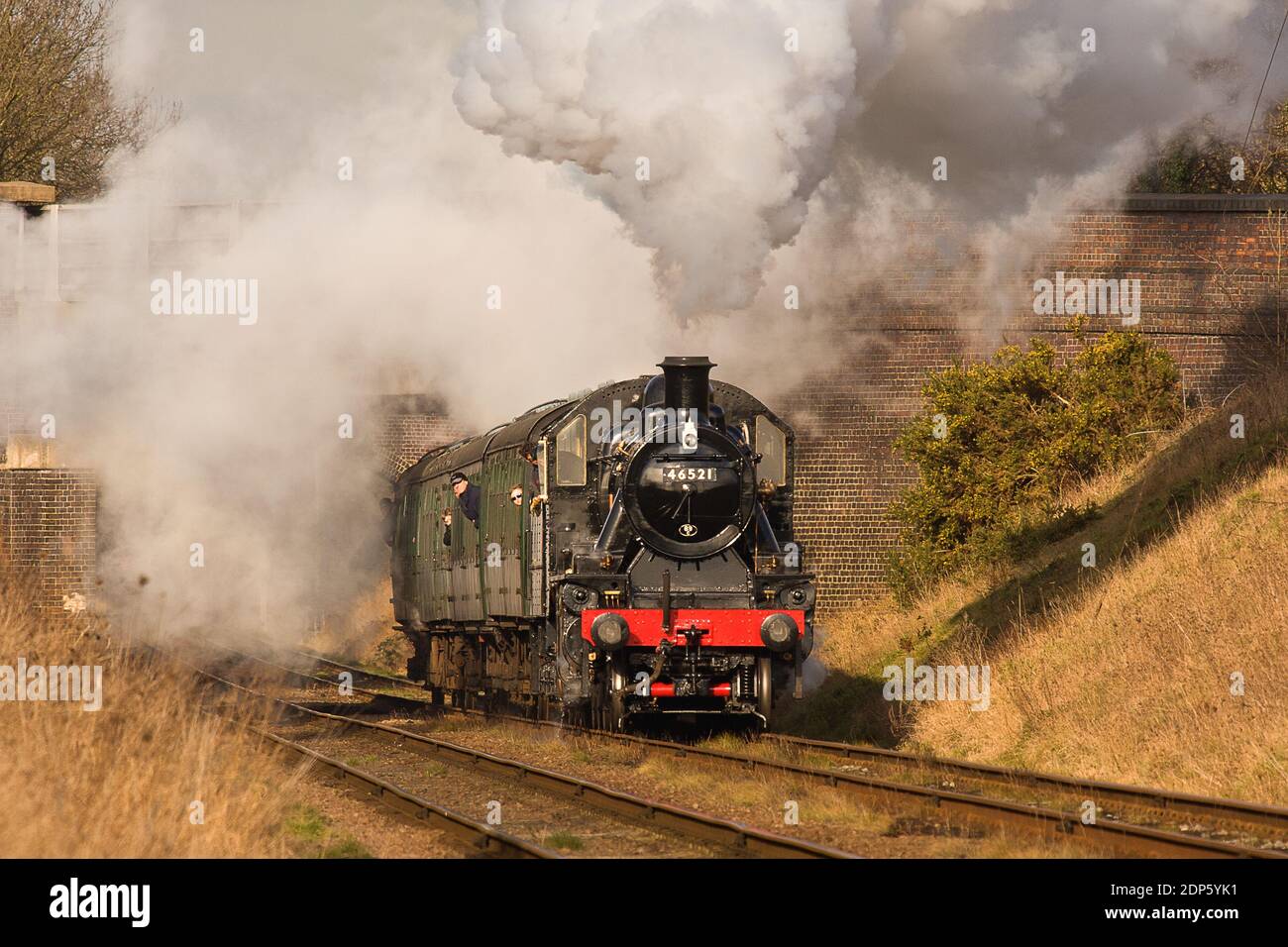 LMS Ivatt Class 2 2-6-0 No. 46521 catches the sun as it powers south ...