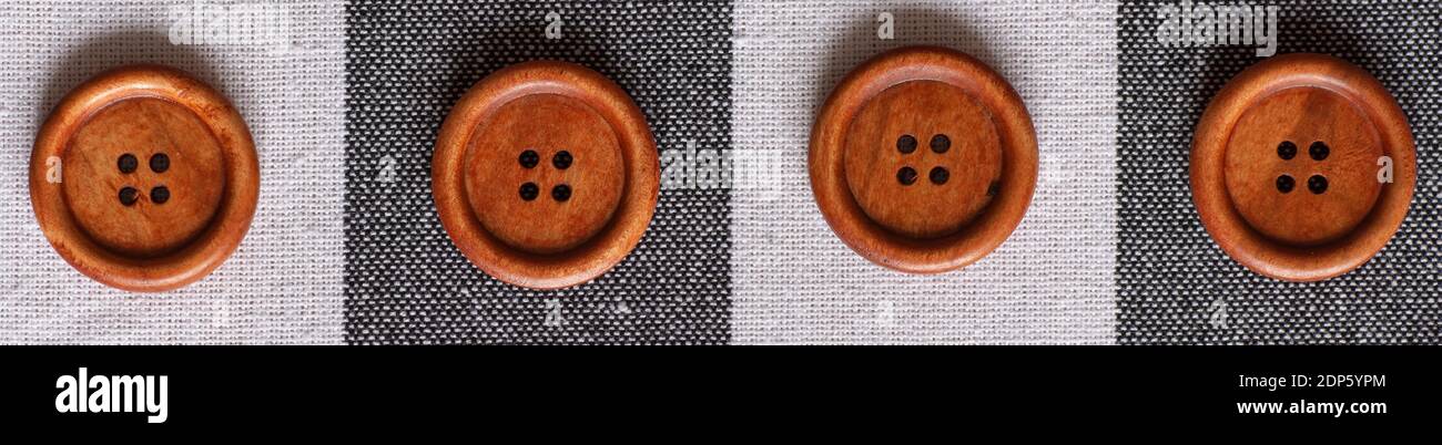 Round wooden brown sewing buttons isolated on textile background. Top view . Close up. Macro. Stock Photo