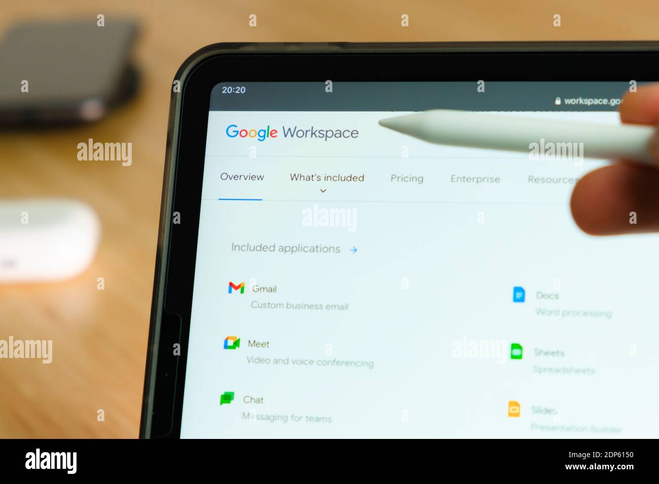 Google Workspace logo shown by apple pencil on the iPad Pro tablet screen.  Man using application on the tablet. December 2020, San Francisco, USA  Stock Photo - Alamy