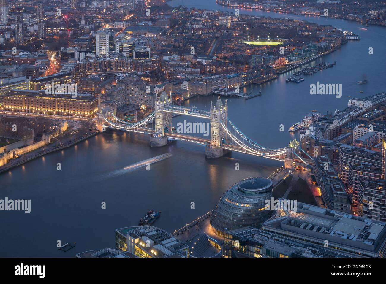 Illuminated Tower Bridge at blue hour dusk from above in a cloudy day ...