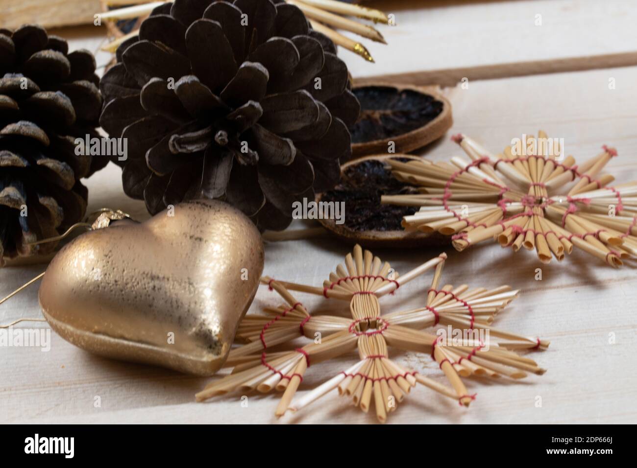 Old Christmas tree balls and pine cones on rustic wooden boards as Christmas decorations. Stock Photo