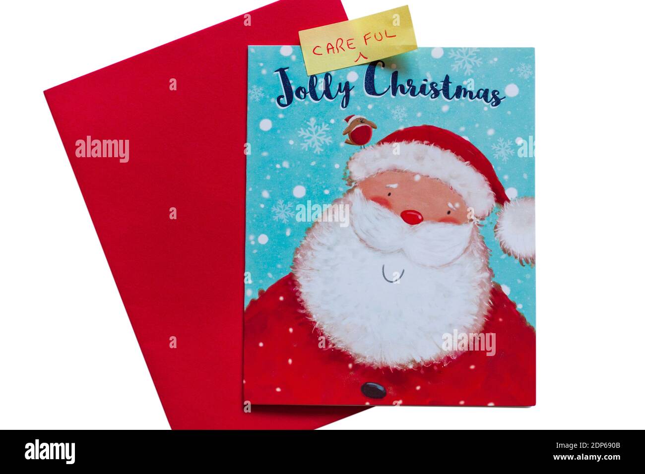 Have a Jolly Careful Christmas - Jolly Christmas card with red envelope with word Careful added due to Coronavirus Covid 19 pandemic and restrictions Stock Photo