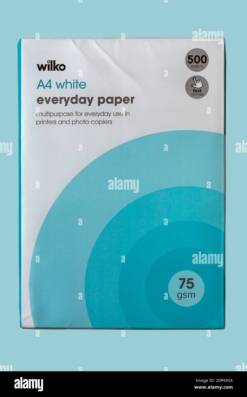 Pack of Wilko A4 white everyday paper multipurpose for everyday use in printers and photo copiers isolated on pale pastel blue background - 500 sheets Stock Photo