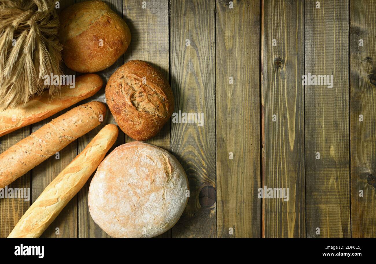 Different fresh bread on a wooden table Stock Photo