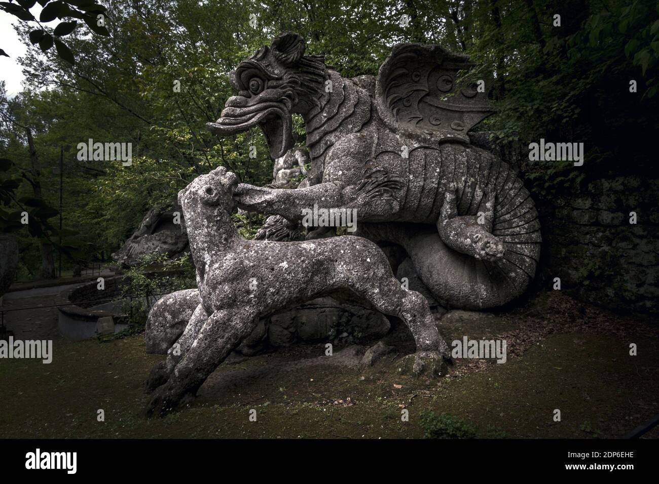 The large statue of the Dragon bitten by a lion and a  at the famous Gardens of Bomarzo, Viterbo Stock Photo