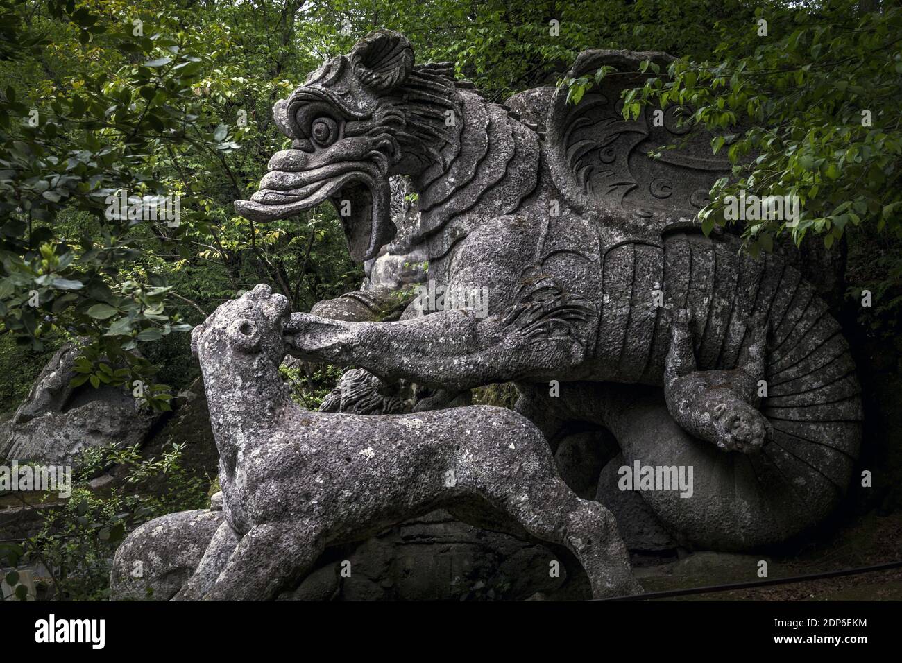 The large statue of the Dragon bitten by a lion and a wolf at the famous Gardens of Bomarzo, Viterbo Stock Photo