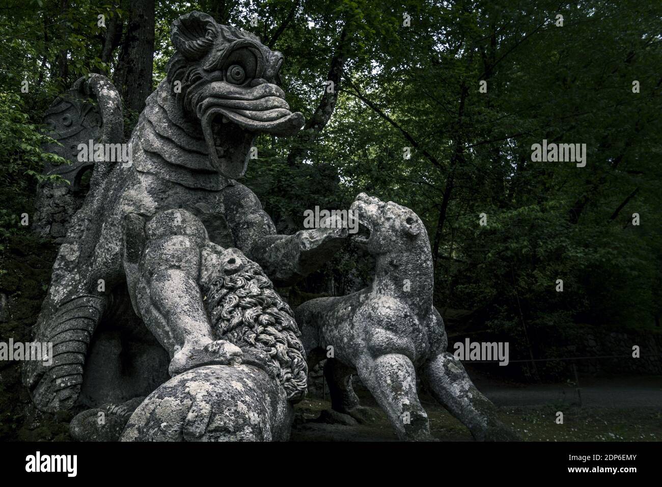 The large statue of the Dragon bitten by a lion and a wolf at the famous Gardens of Bomarzo, Viterbo Stock Photo