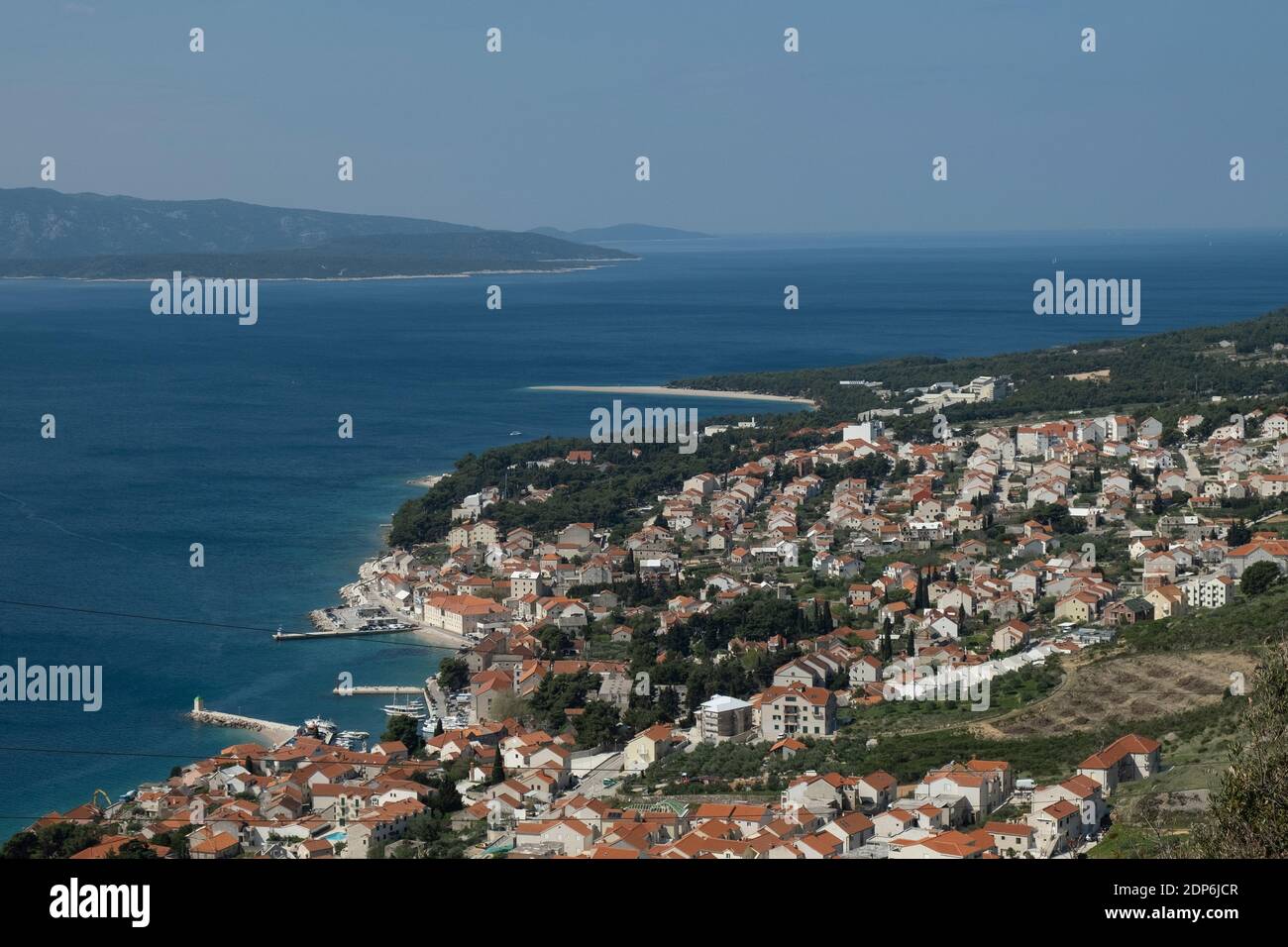 Aerial view of the old town of Bol with harbour and Zlatni Rat in the background, Brac Island, Dalmatia, Croatia, Europe. Stock Photo