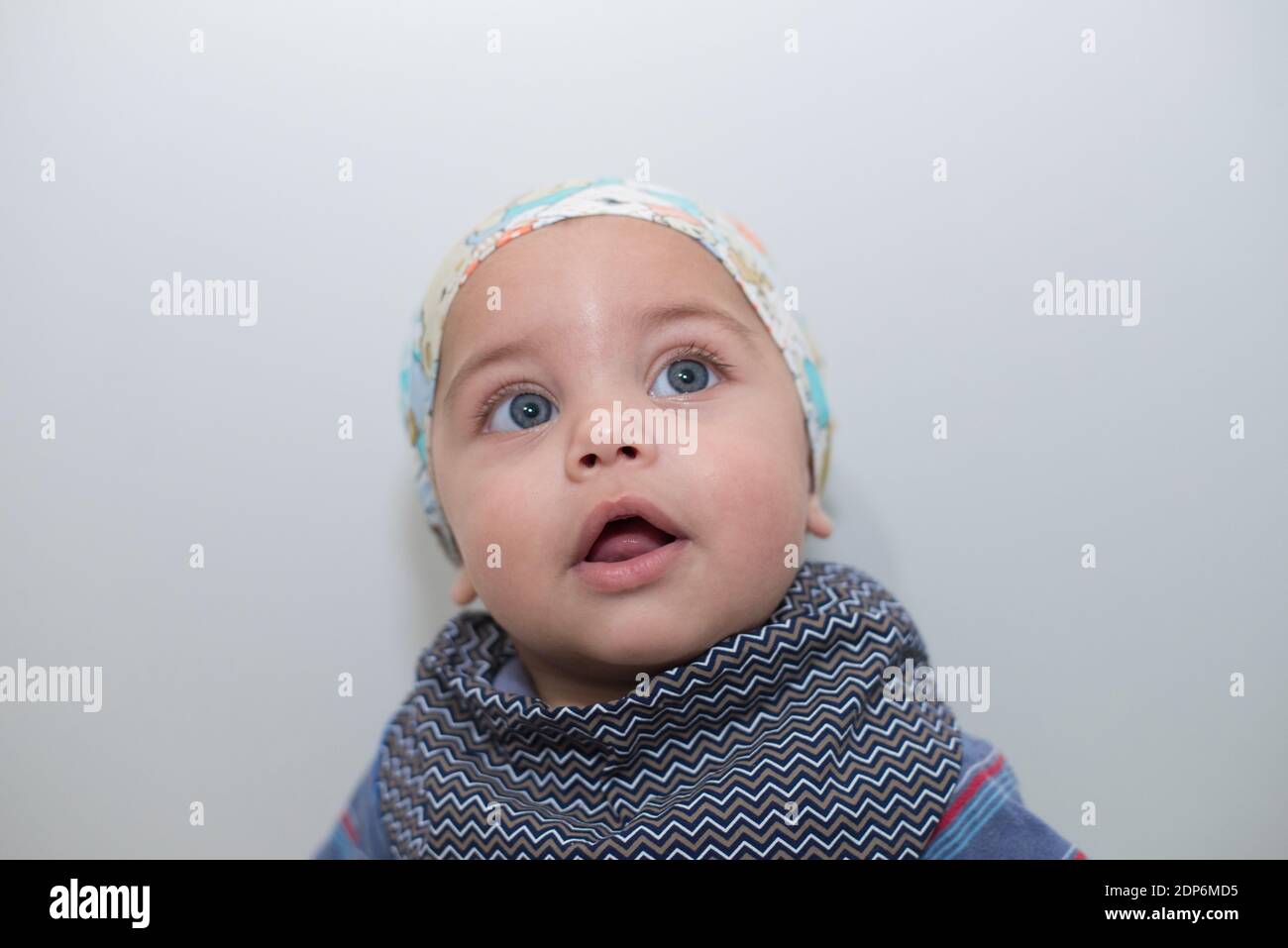 Blue-eyed baby boy with bandana on head Stock Photo - Alamy