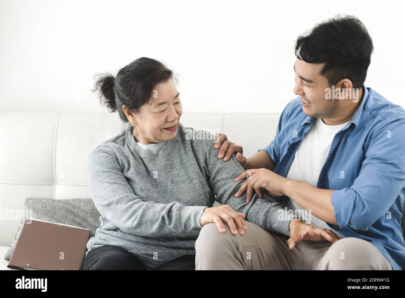 Asian man massage his mother at home, lifestyle concept Stock Photo - Alamy