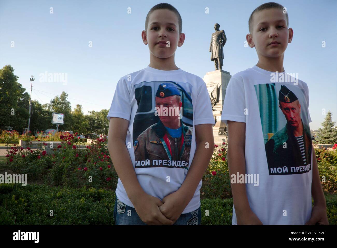 Sevastopol, Crimea, 24th of July, 2015 Boys stand on Nakhimov square with a portrait of Russian president Vladimir Putin on t-shirts against the background of the monument to Pavel Nakhimov in the center of Sevastopol city, Crimea Republic Stock Photo