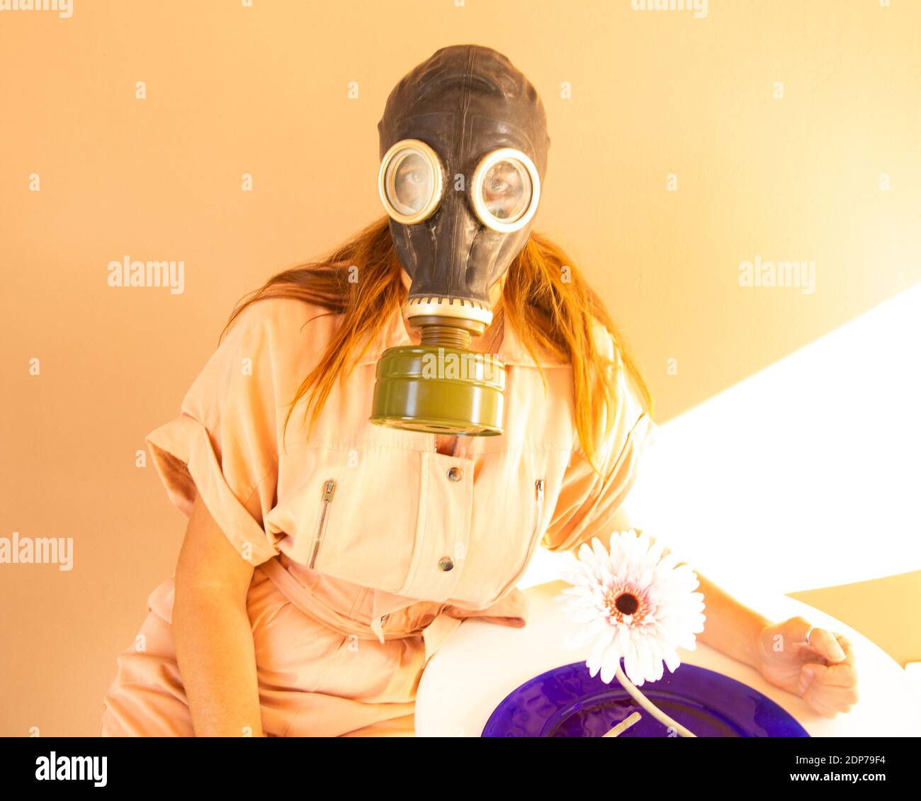 Portrait Of Woman Wearing Gas Mask Against Wall Stock Photo Alamy
