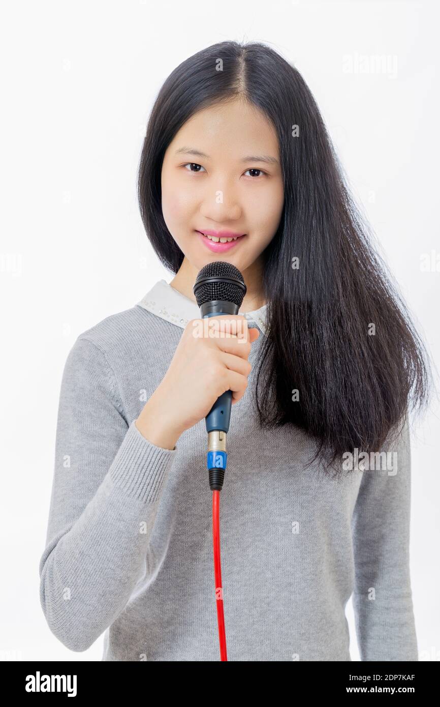 Chinese Taiwanese teenage girl holding microphone Stock Photo