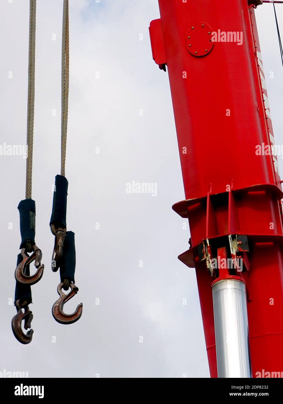 Detail of a red heavy-lift crane boom with hooks Stock Photo
