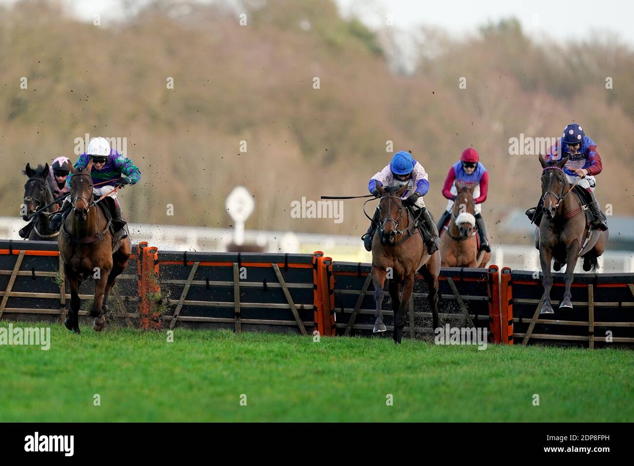 Aidan Coleman riding Paisley Park (right, spotted cap) clear the last to win The Porsche Long Walk Hurdle from Richard Johnson and Thyme Hill (left, white cap) during the Saturday of the December Racing Weekend at Ascot Racecourse. Stock Photo