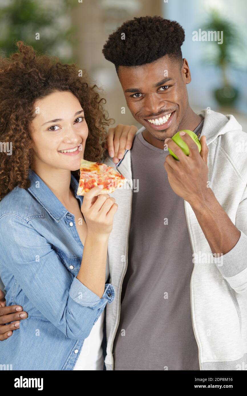 a couple eating different food Stock Photo