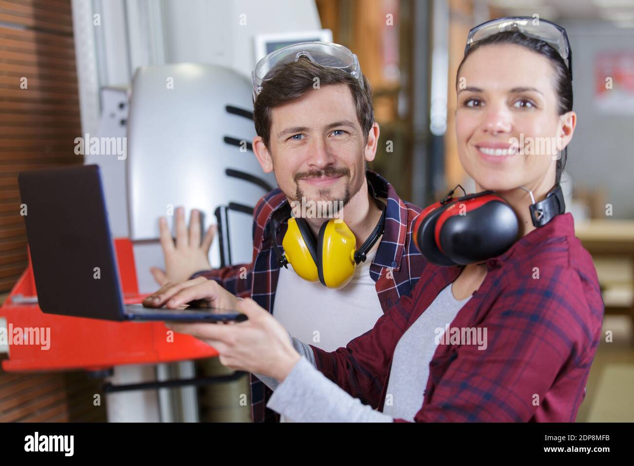carpenter teaching apprentice how to cut wood Stock Photo Alamy