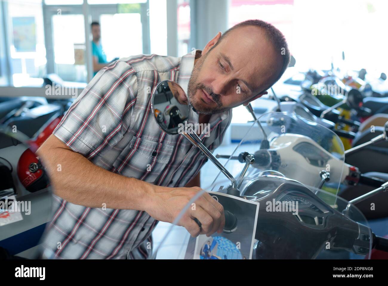 a man testing a scooter Stock Photo