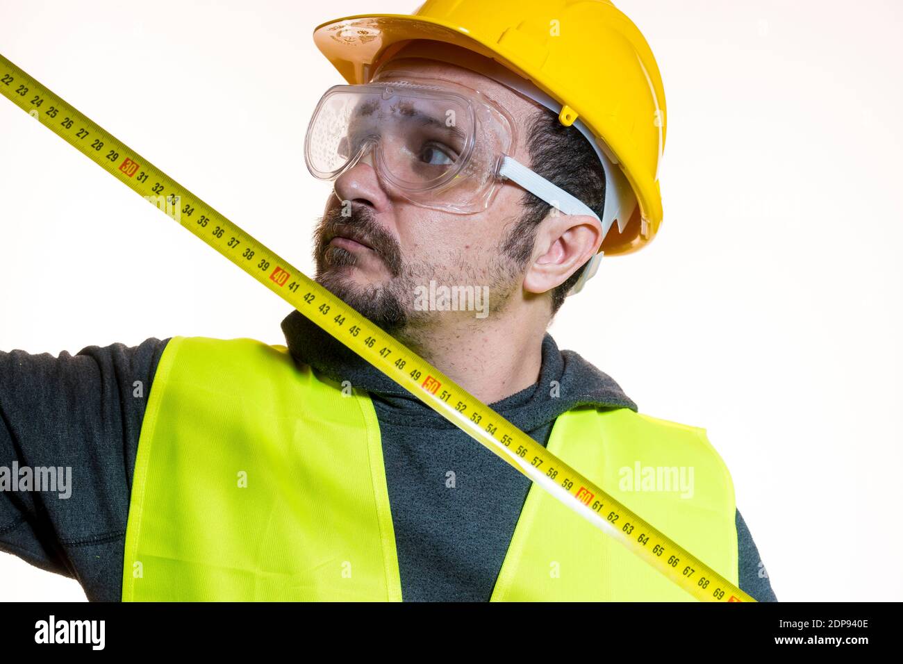 Architect Measuring With Tape Measure Against White Background Stock
