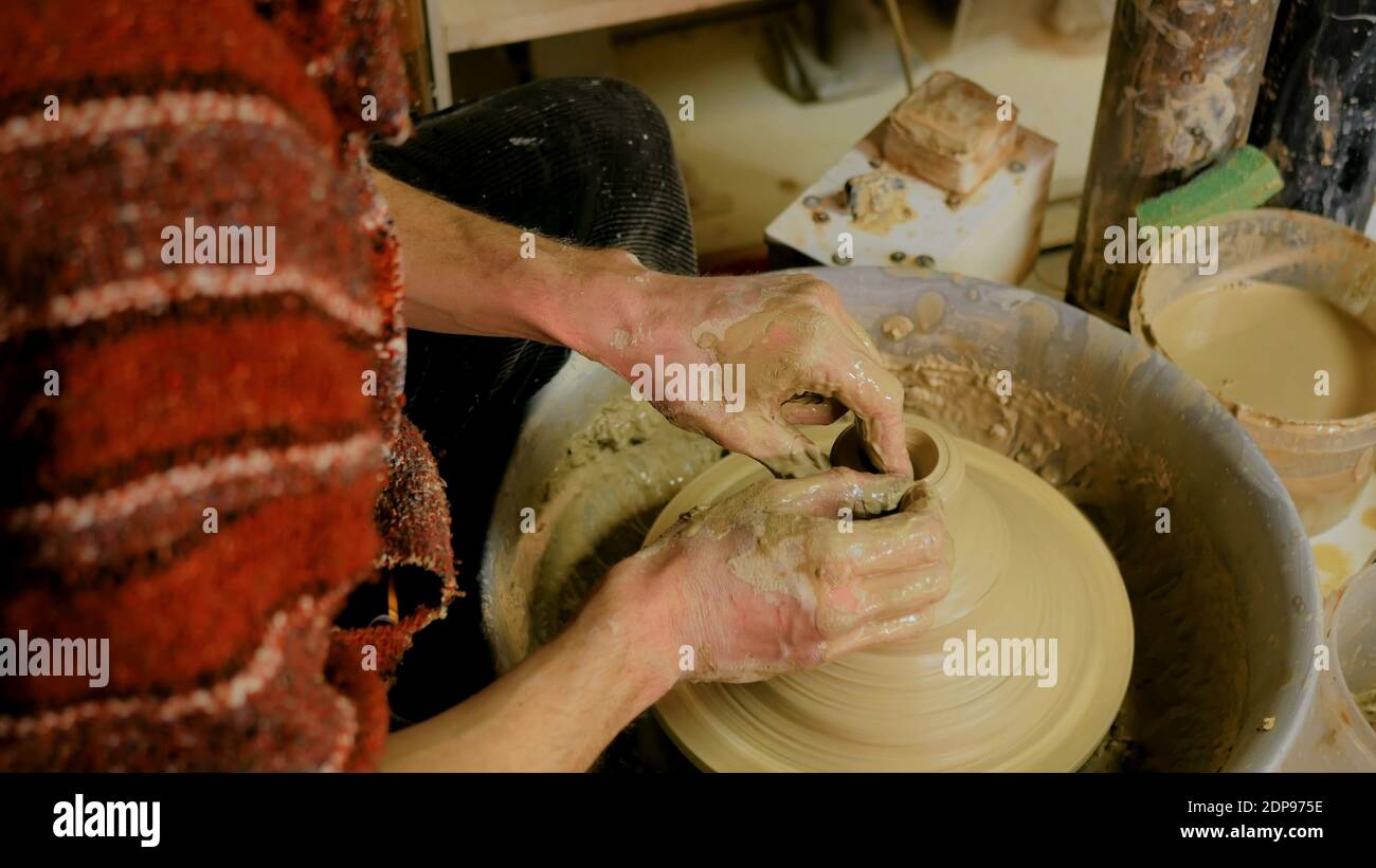 Professional male potter making mug in pottery workshop Stock Photo - Alamy