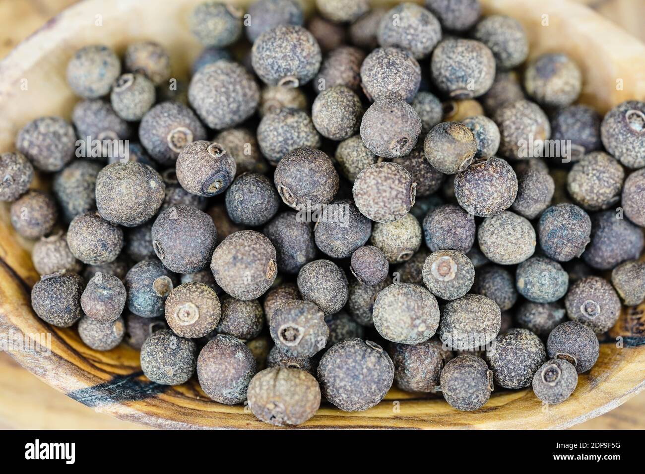 some allspice balls on olive wood Stock Photo Alamy