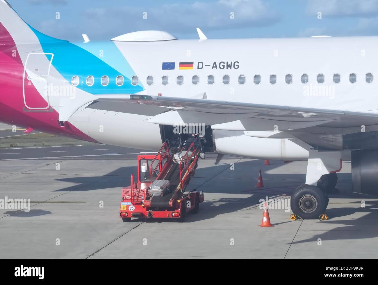 Eurowings airplane at Faro airport in park position is loaded with luggage Stock Photo