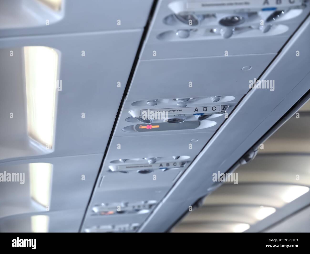 The world of aircraft - Passenger instruments inside the ceiling of an airplane Stock Photo