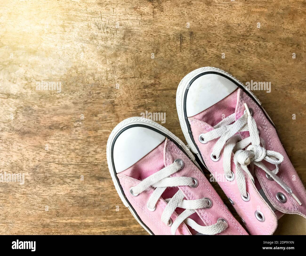 Pink canvas shoes on wooden background,woman shoes Stock Photo - Alamy